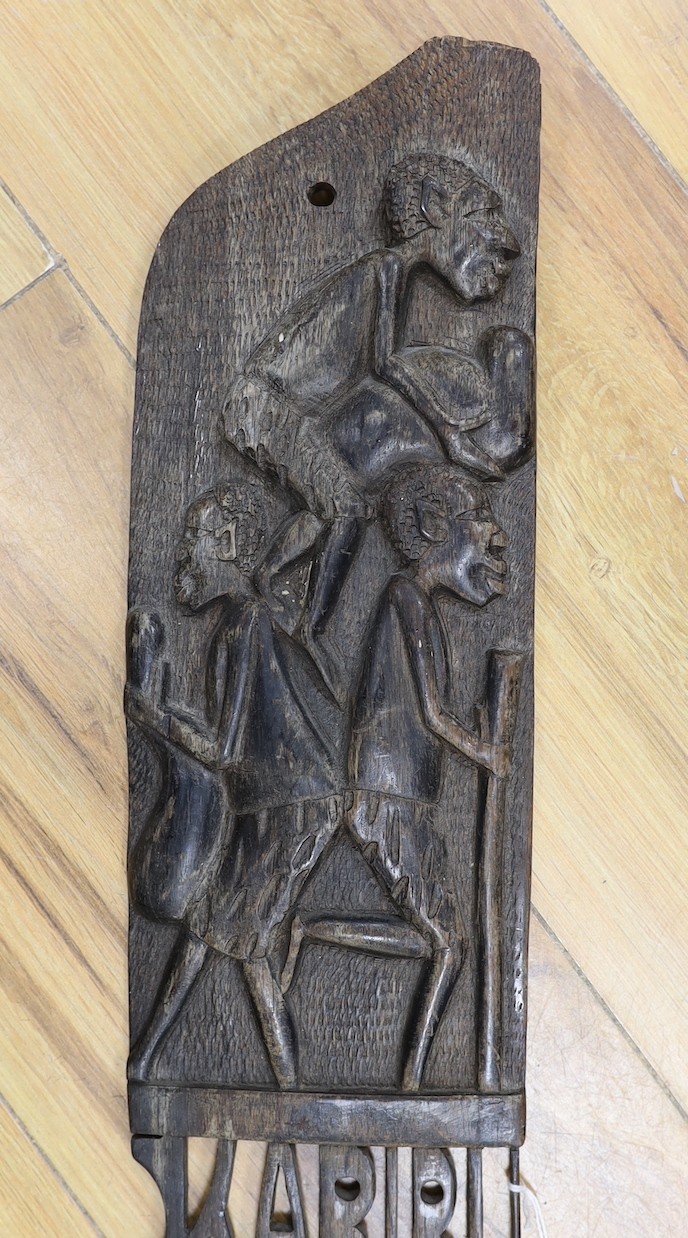 An African carved hardwood comb, Swahili , 83 cms long.